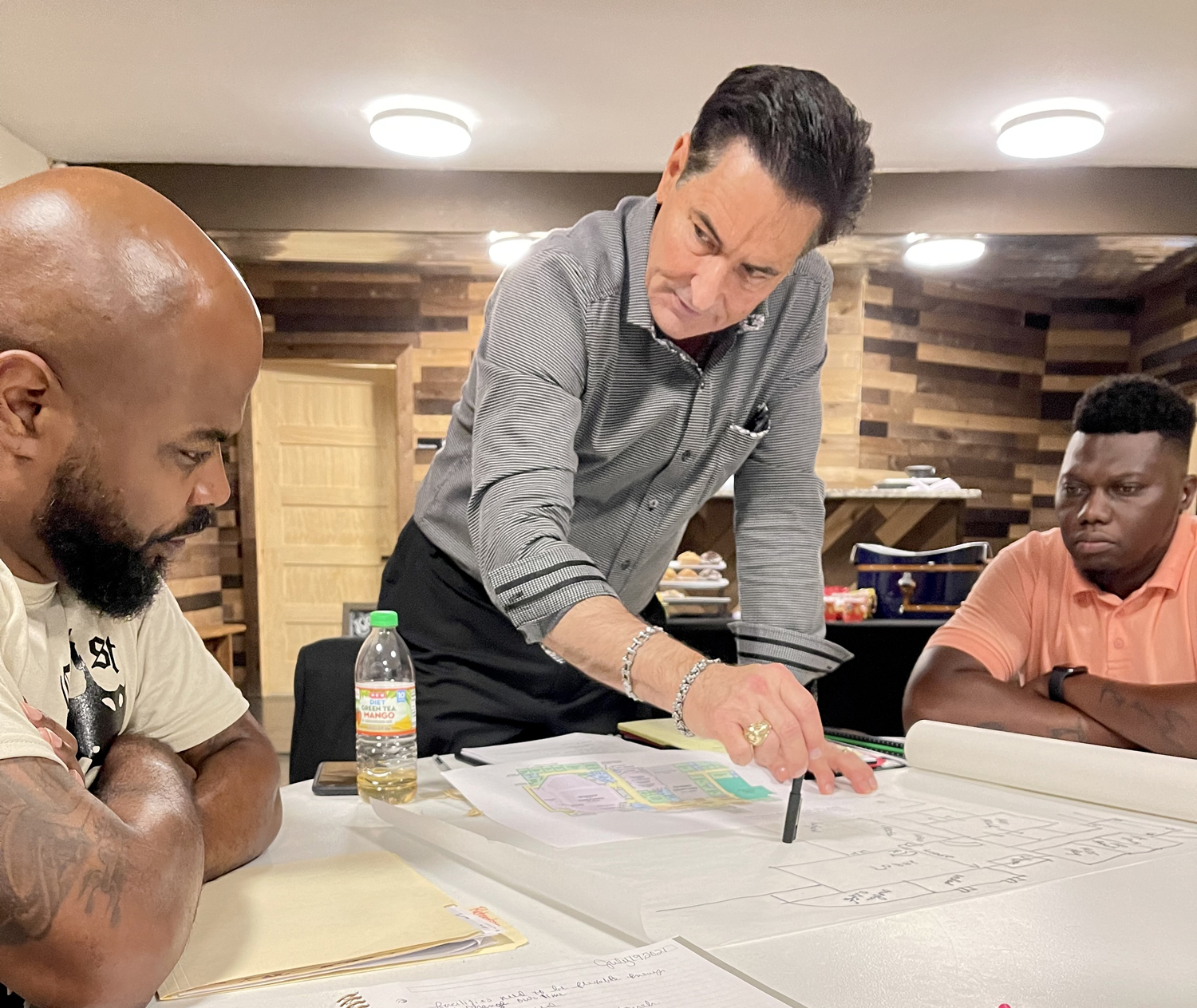Steve Upham walking a church team through floor plans during a Design Summit